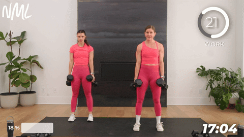 two women performing a squats with dumbbells.