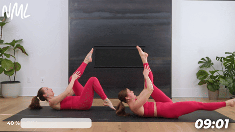 two women performing straight leg pulls in a mat pilates workout