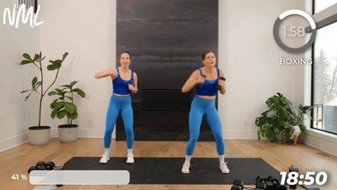 two women performing a front jab and press jack in a boxing workout at home