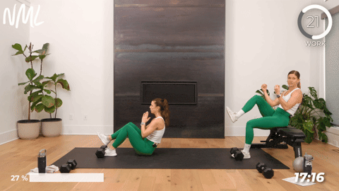 two women performing a hip flexor crunch in a core workout