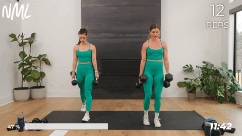 two women performing a lunge in a leg and glute workout