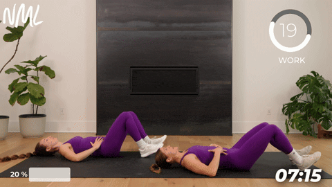 two women performing a supine march with an eccentric leg lower as part of the best pelvic floor exercises