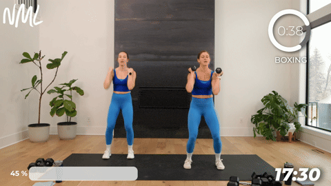 two women performing an elbow block and press jack in a boxing workout at home