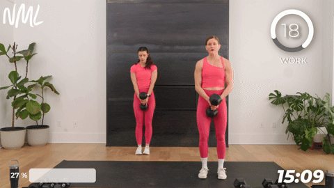 two women performing lateral lunges with dumbbells.