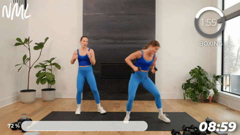 two women performing a beatdown and jab in a boxing workout at home