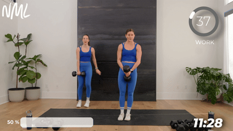 two women performing lateral lunges with dumbbells.