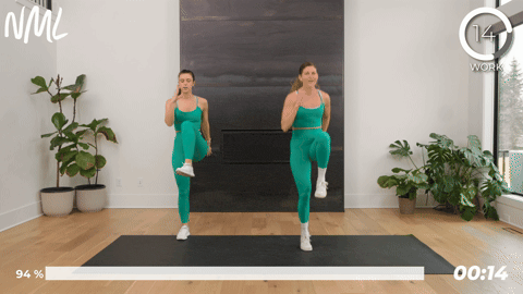 2 women performing high knee skips as part of pre running stretches