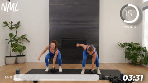 two women dumbbell snatches.