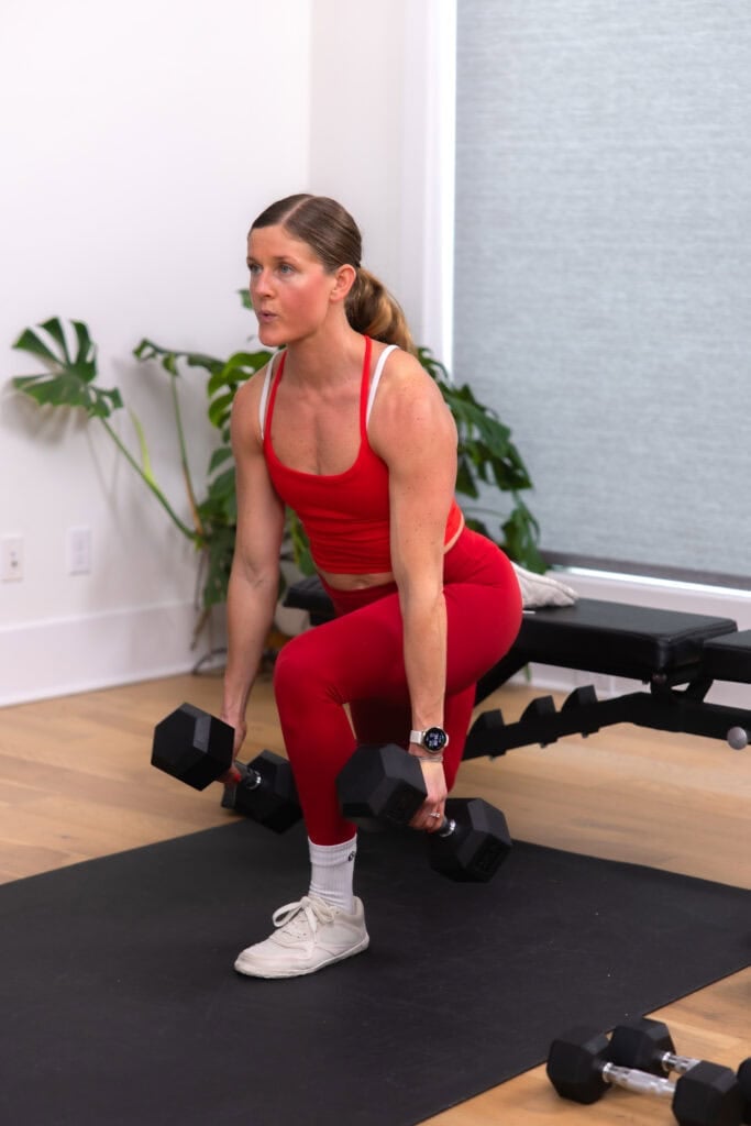 woman performing a bulgarian lunge with dumbbells in a lower body workout