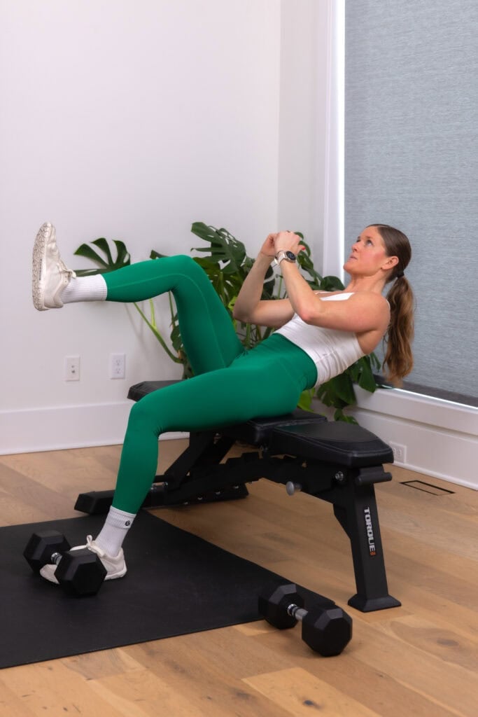 woman performing a hip flexor crunch in a core workout