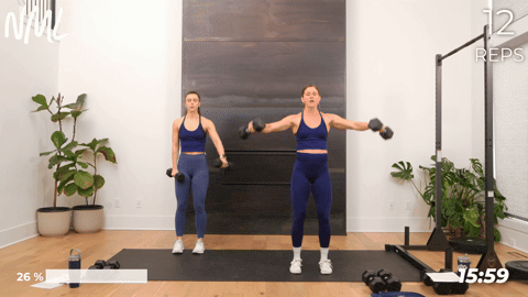 two women perform lateral raises as part of a back and arm workout