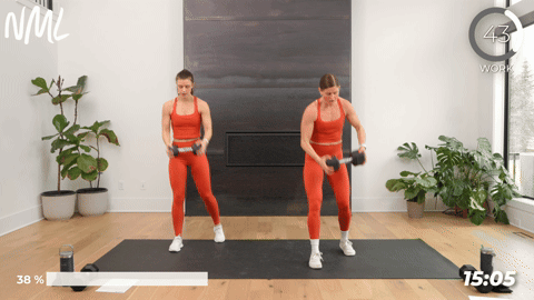 Two women doing a step through dumbbell woodchop as part of a calves and core workout. 