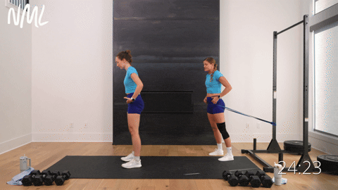 woman performing a banded hip hinge as part of the best hip hinge exercises