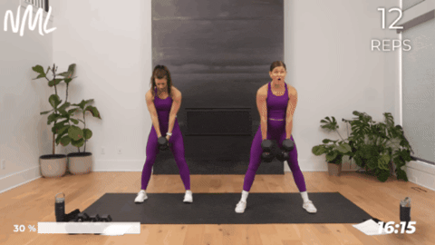 women performing a glute biased squat with dumbbells as part of full body workout