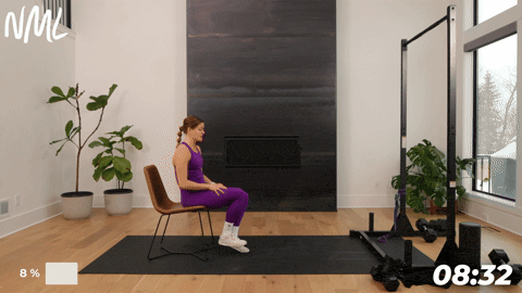 woman performing a seated knee extension as part of knee mobility exercises to build strength and stability
