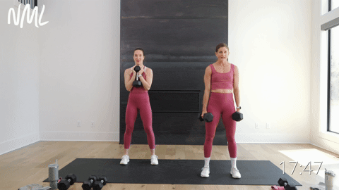 two women performing dumbbell squats in a knee friendly leg workout