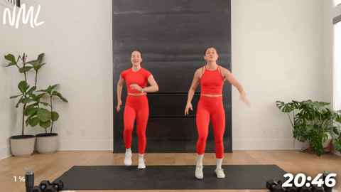 two women walking in place as part of a walking workout at home
