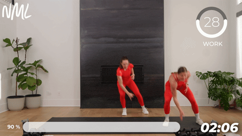 two women demonstrating a lateral shuffle in a walking workout at home