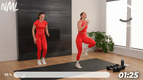 two women performing high knee sprints in a walking workout at home