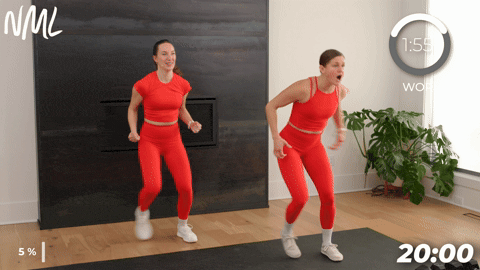 two women performing lateral side steps in a walking workout at home