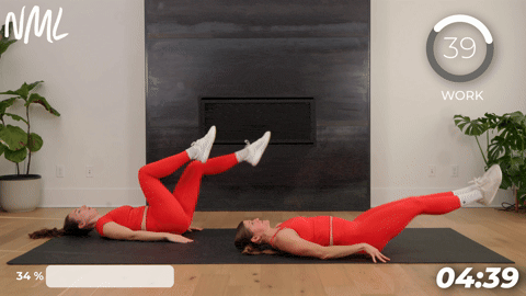 two women performing a reverse crunch hip lift in a quick ab workout