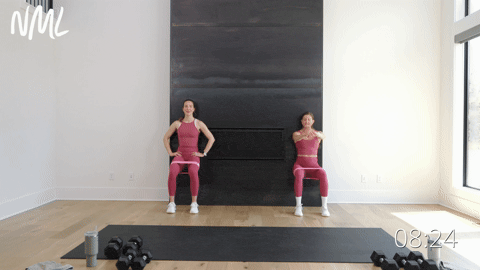 two women performing a wall sit with a band in a knee friendly leg workout
