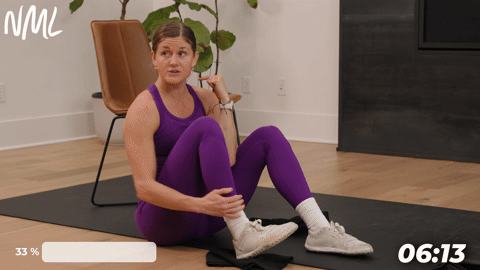 woman performing seated heel slides as part of knee mobility exercises to build strength and stability
