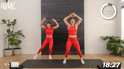 two women demonstrating low impact jumping jacks in a walking workout at home