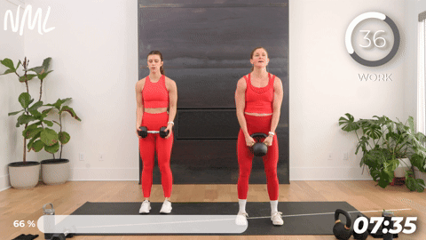 two women performing bicep curls in a 20 minute kettlebell workout