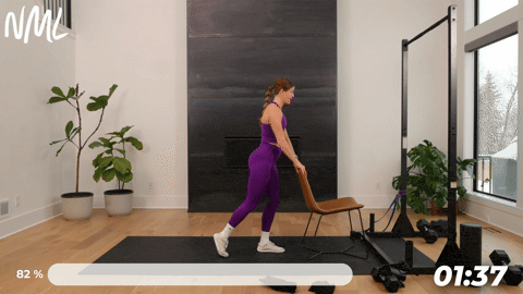 woman performing standing hamstring curls as part of knee mobility exercises to build strength and stability