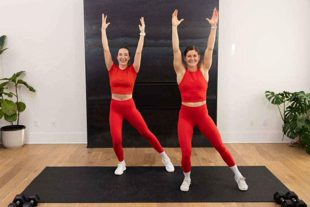 two women demonstrating alternating tap outs as part of a walking workout at home