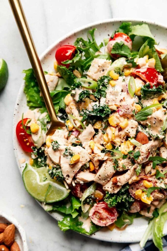 Creamy BBQ chicken salad with chicken, corn, mixed greens, tomatoes, lime and BBQ dressing.
