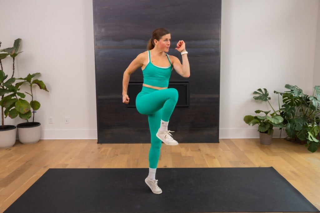 Woman performing high knees.