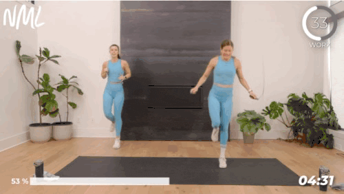 Two woman working out doing 2 count single leg switches with a jump rope.