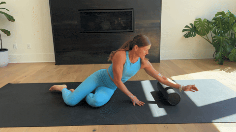A woman doing side lying tricep stretches