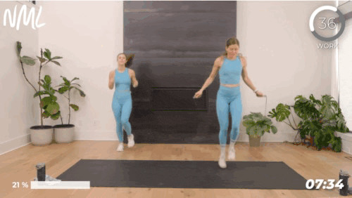 Two woman working out doing alternating foot jumps with a jump rope.
