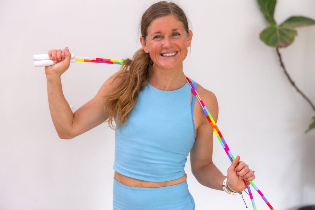 Woman in a blue outfit holding a jump rope.
