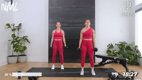 Two women performing flip grip bicep curls as part of a chest and arm workout.