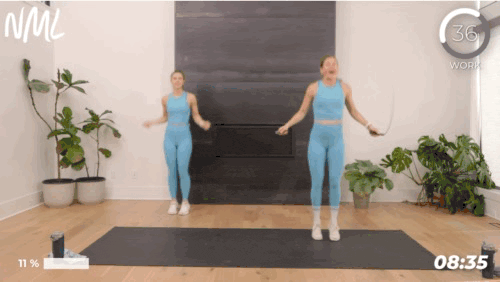 Two woman working out jumping rope.