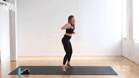 A woman working out doing jab cross speedbags.