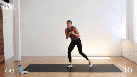 A woman working out doing hook and tap exercises.