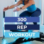 Women doing a box jump as part of a 300 rep workout