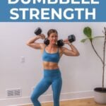 woman holding dumbbells racked at her shoulders as part of a full body strength building workout